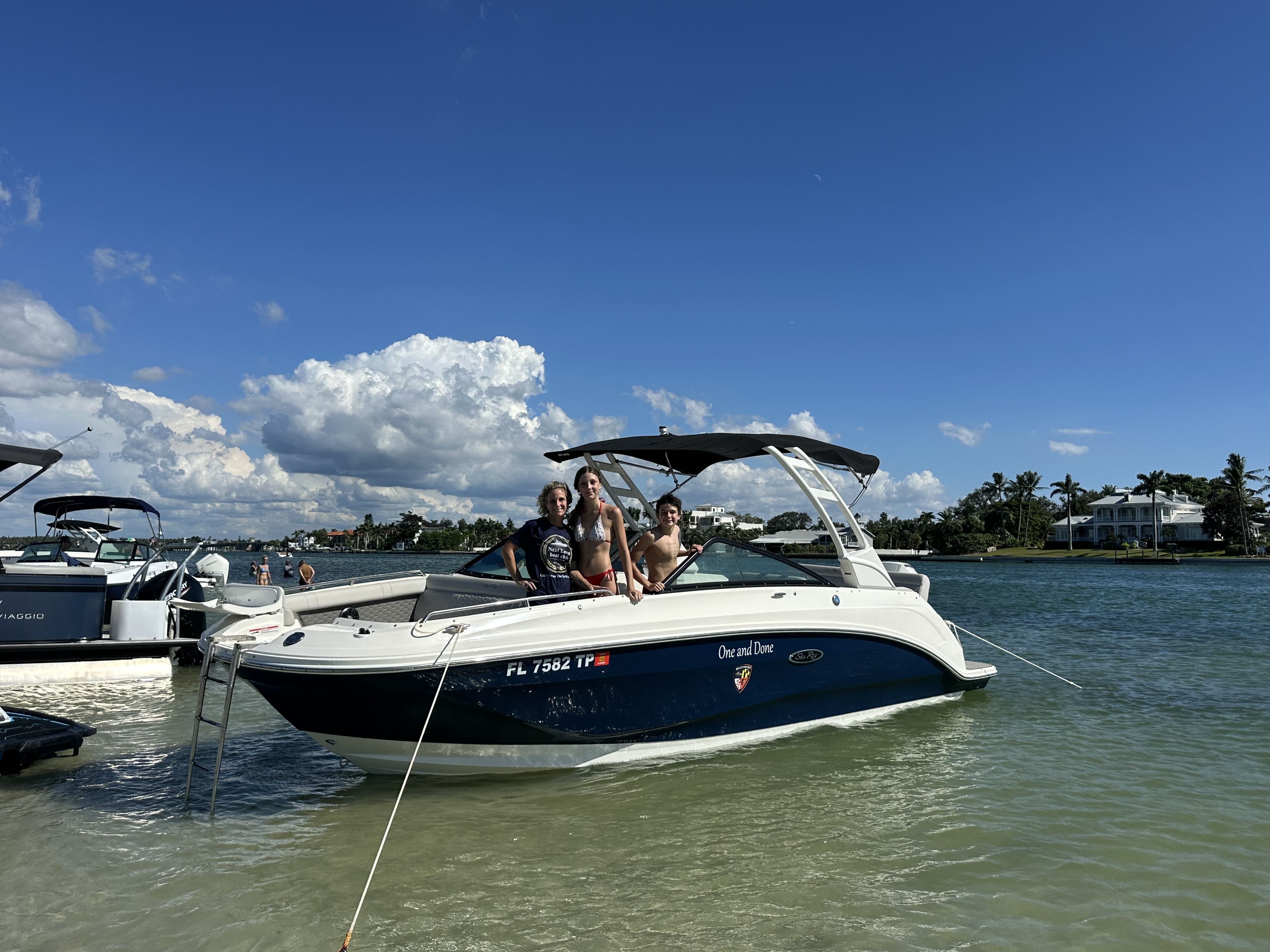 Three people on a boat in shallow water